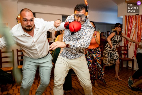 At L’héritage in Poliénas, Isère, France, guests get competitive during a lively wedding game, with playful energy turning into a spirited fight and laughter.