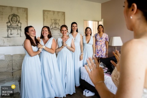 At Domaine de la Chartrognière in St Thomas en Royans, Drome, France, a bridesmaid grows emotional during the first look with the bride, capturing a touching moment of friendship and anticipation.