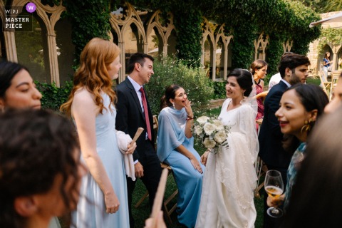 At El Peregrino wedding venue in Navarra, Spain, the bride and guests mingle and laugh together during cocktail hour, savoring a beautiful celebration along the Way of Saint James.