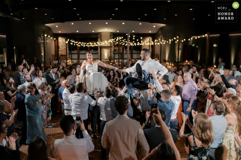 At OSRUI in Oconomowoc, Wisconsin, the dance floor overflows as every guest joins the couple for a lively Hora Dance, with a dynamic wide view capturing the festivities.