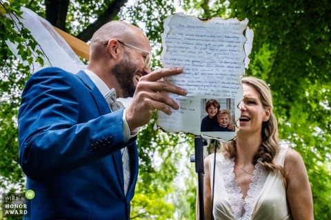 A Poignant Vow Exchange Takes Place Surrounded By Lush Vineyard Scenery At Weingut Hahn In Germany Weingut Hahn in Alzey, Germany, sets the stage for a poignant ceremony moment, with the couple exchanging vows surrounded by friends, family, and lush vineyard scenery.