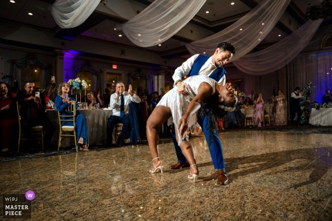 At Menden Hall Inn, the couple shares a romantic dip reminiscent of a gymnastic backbend, embracing with passion and trust in a timeless, elegant moment.