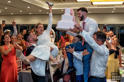 At Vega del Barco in Linares, Jaén, Spain, the wedding party gathers for the memorable cake topper grabbing, sharing laughter and sweet moments around the dessert table.