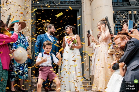 Following their ceremony at the venue in Yvelines, the bride and groom exit joyfully, ready to greet waiting friends and family as newlyweds.
