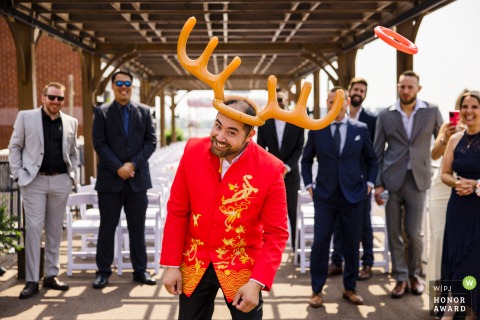 Inside Montreal’s Hotel Nelligan, the groom dons inflatable antlers and attempts to catch a tossed ring, while relatives watch with laughter and anticipation.