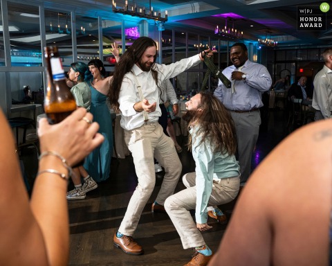 Oceanview of Nahant in Nahant, MA, hosts a spirited celebration as the groom and his lookalike groomsman let their long hair loose together on the dance floor.