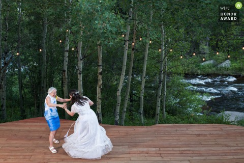 The Bride Invites Her Mother To The Dance Floor At Wild Basin Lodge In Allenspark Colorado At Wild Basin Lodge in Allenspark, Colorado, the bride invites her mother to the dance floor for a special first dance, honoring the person who taught her how to dance.