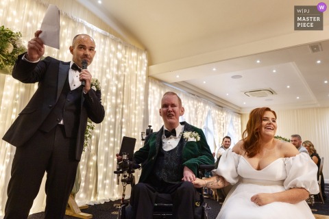An emotional best man delivers his speech at The Shandon Hotel in Dunfanaghy, Co Donegal, while the bride and groom watch attentively, capturing a heartfelt and memorable moment from the celebration.