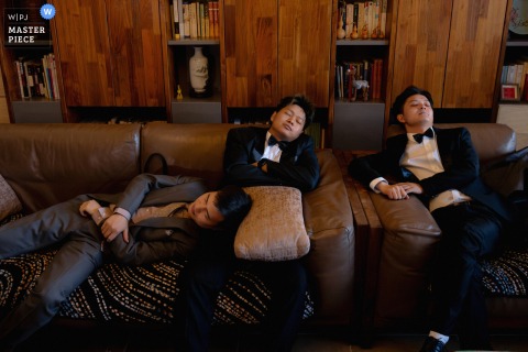 At a home in Taiyuan, Shanxi, the groom and his best man, worn out from the excitement of the wedding day, fall asleep together on the sofa.