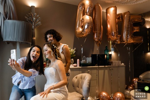 Guests Pose Together For A Cheerful Group Selfie During A Lively Wedding At Wyndham Grand Kalamis In Istanbul During the wedding at Wyndham Grand Kalamis in Istanbul, Turkey, a lively moment unfolds as guests pose together for a cheerful selfie.