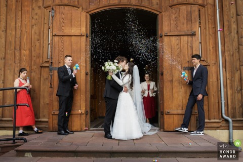 The newlyweds step out of the church, greeted by friends and family, marking the official start of their married life in the heart of Krakow, Malopolskie.