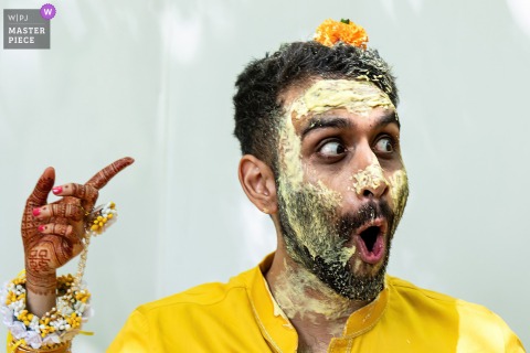 A Flower Lands On The Groom’s Head, Surprising The Couple In The Backyard Of Their Northside Drive, Atlanta Home. In the backyard of a home on Northside Drive in Atlanta, the bride and groom share a surprised reaction when a flower unexpectedly lands on the groom’s head during their celebration.
