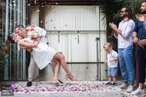 Joyful Friends And Family Surround The Couple For A Dip And Kiss At Château La Hitte, Bringing Festive Energy To The French Estate. At Château La Hitte in France, bride and groom dip/kiss and celebrate their union with friends and family, surrounded by the elegance and charm of this historic French estate.