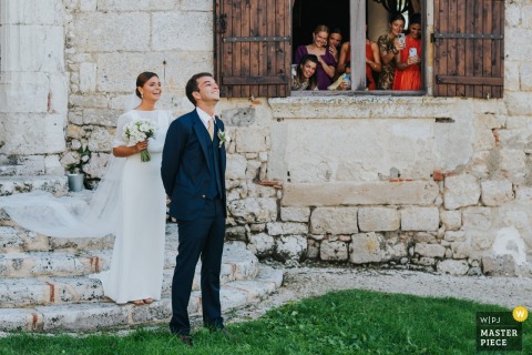   Anticipation fills Domaine de Pleneselve in Bon Encontre as the couple prepares for their imminent first look, hearts racing just before their eyes meet on their special day.