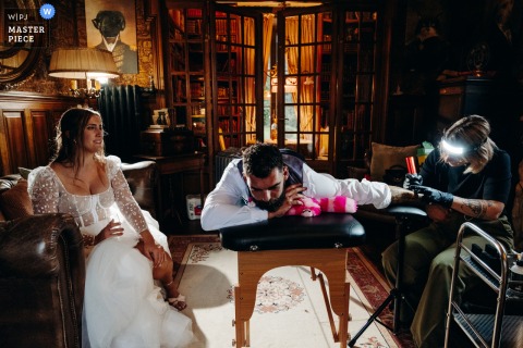   A unique scene unfolds at Chateau de la Croix, where the groom gets a tattoo on his wedding day, marking the occasion with a permanent, meaningful tribute.