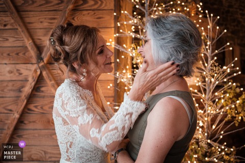   Domaine la Verrerie in Dinan, Brittany, sets the scene for a warm moment between the bride and one of her best friends as they enjoy the cocktail hour together.