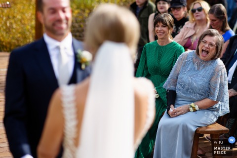A Mother’s Emotional Reaction Takes Center Stage During The Ceremony At Piney River Ranch, Set Against Colorado's Mountains. During the ceremony at Piney River Ranch, the mother of the groom’s emotional reaction is visible, adding a deeply personal touch to the stunning outdoor setting.