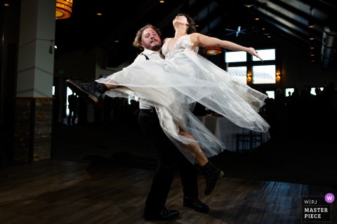 High Spirits At Lunch Rock, Winter Park Resort, Colorado As The Groom Lifts The Bride In Their Exuberant First Dance. Excitement fills Lunch Rock at Winter Park Resort as the groom lifts the bride during their first dance, impressing guests and starting off the evening’s celebration on a high note.