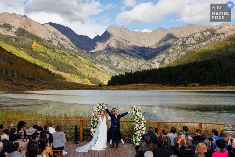 Celebratory Joy Radiates From The Couple At Piney River Ranch, Colorado As They Turn To Their Guests After The Ceremony. The bride and groom at Piney River Ranch bask in celebration, turning toward their guests with joy at the conclusion of their ceremony in the Colorado mountains.