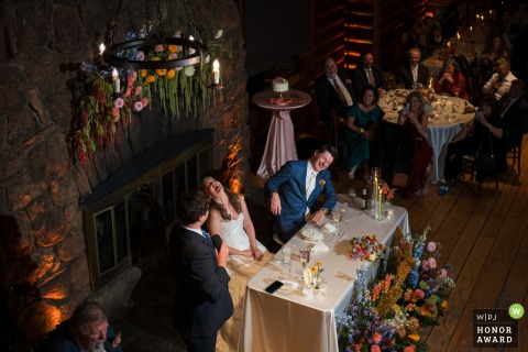 Well Timed Joke Brings Laughter And Smiles To Couple And Guests At Black Canyon Inn In Estes Park, Colorado Laughter fills Black Canyon Inn in Estes Park, Colorado, as a perfectly timed joke during the toasts has guests and the happy couple celebrating with big smiles.