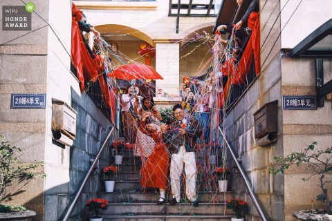 In Nanping, Fujian, the bride and groom step out from their home together, heading to attend the ceremony with joyful anticipation on their wedding day.