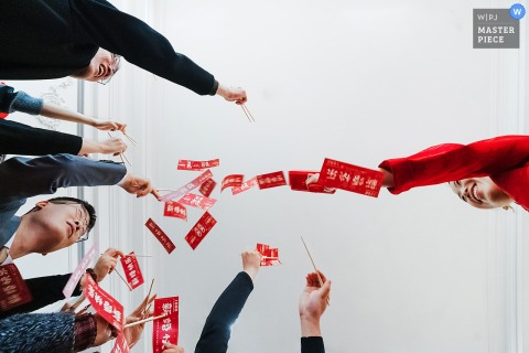 Cheers Surround The Newlyweds As They Take Part In Gate Crashing Door Games During A Joyful Ritual In Binzhou, Shandong. At home in Binzhou, Shandong, the newlyweds participate in traditional gate crashing wedding door games, surrounded by friends and family cheering them on during this lively pre-ceremony ritual.