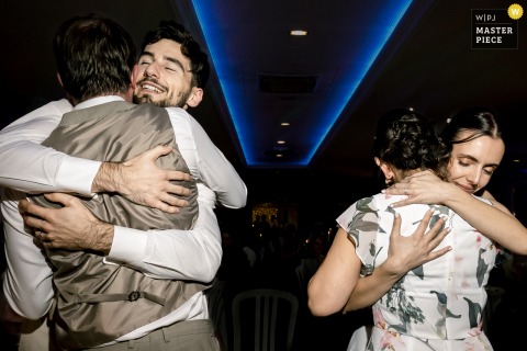 After Parent Speeches In Pau, Pyrenees-Atlantiques, Emotional Double Hugs Connect The Couple With Family During Dinner. A wave of touching emotions sweeps the dinner at a reception venue in Pau, Pyrénées-Atlantiques, as the couple exchanges double hugs with family after heartfelt parent speeches.