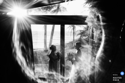   In Tulum, bw film photography creates an unexpected halo around the couple, enhancing the composition with a dreamy effect in this intimate wedding scene.