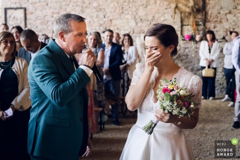 As the bride's father escorts her down the aisle at a Rhône ceremony location, he pauses to serenade her with You Raise Me Up, bringing her to tears and enchanting the guests.