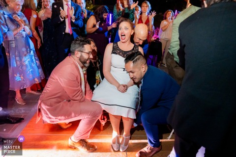   At The Newhall Mansion in Piru, California, the bride beams with anticipation as friends and family prepare to lift her up during the lively hora dance.