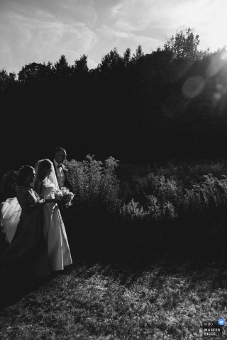   Moments before walking down the aisle at her family home in Windham, NY, the bride pauses, anticipation and excitement evident as she prepares to begin her journey down the aisle.