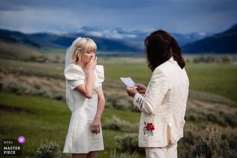 Surrounded By Yellowstone’s Dramatic Scenery, The Couple Exchanges Heartfelt Vows With Nature Providing Their Awe-Inspiring Backdrop. Amid the stunning landscape of Yellowstone, the couple faces one another to exchange heartfelt vows, with nature providing a breathtaking ceremony backdrop.