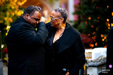   A wave of emotion overtakes the groom at Woodland Park, NJ, as he and his aunt share a heartfelt moment, tears reflecting the depth of family bonds.