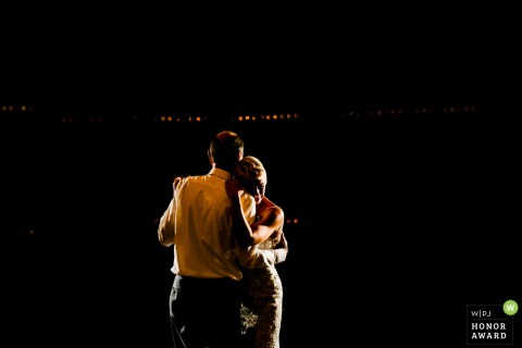 During the Avonlea Farms celebration in Mineral, Virginia, a father and daughter enjoy a touching dance together beneath the warm lights of the venue.