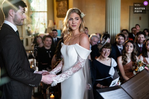   Hampton Court House in Surrey, England, holds a ceremony filled with heartfelt emotion, as guests and the couple are moved to tears by the significance of the moment.