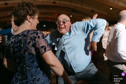 Elbows Fly And Joy Abounds As A Guest Dominates The Dance Floor At Croatian Park In Franklin, Wisconsin. At Croatian Park in Franklin, Wisconsin, one enthusiastic guest really lets loose on the dance floor, throwing elbows and having the time of his life during the festivities.