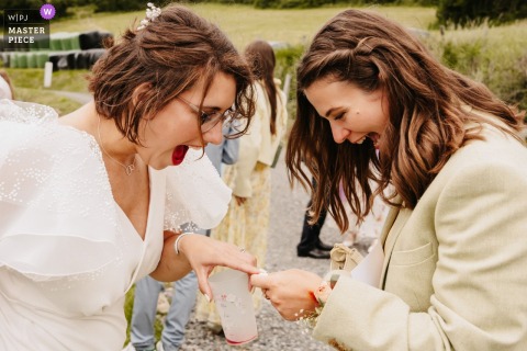   During cocktail hour at Domaine des Monts du Lyonnais in Rhône, the bride and her best friend excitedly discover they’re wearing matching nail polish, sharing laughter and surprise over the coincidence.