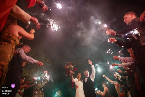 Sparklers Light Up The Winter Night As Guests Celebrate Tradition At Harvey’s Point In County Donegal, Ireland. Guests at Harvey’s Point in County Donegal light sparklers after dinner, their glowing trails illuminating the wintry wedding night in a beautiful display of tradition and celebration.