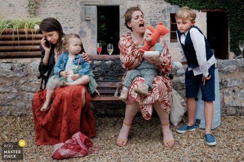 Mums And Children Mingle Playfully During Cocktail Hour In Paris, Filling The Space With City Family Energy. Mums and children mingle during cocktail hour in Paris, laughter and playful energy filling the space as families enjoy the festivities together in a relaxed city setting.
