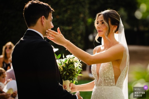   Tears stream down the groom's face at Villa Aurelia in Tuscany, his emotions visible as he stands in the midst of this important and heartfelt outdoor wedding celebration.