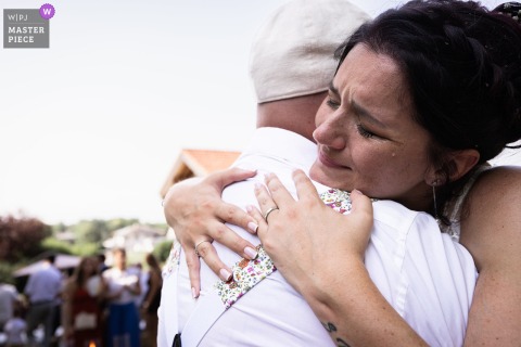 Ceremony In Thonon-les-Bains, Haute-Savoie Features Raw Emotion As Bride Shares A Tender Moment With Her Witness. Raw and heartfelt emotion shines during the ceremony in Thonon-les-Bains, Haute-Savoie, as the bride shares a meaningful moment with her witness in front of gathered family and friends.