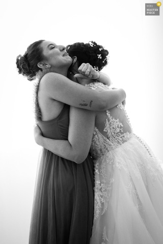 Genuine Love And Connection Shine As Bride Embraces Her Sister Before The Ceremony In Thonon-les-Bains, Haute-Savoie. During wedding preparations in Thonon-les-Bains, Haute-Savoie, the bride embraces her sister, highlighting a genuine moment of love and connection in the midst of excitement.
