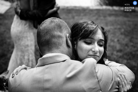   At Grafton Inn in Grafton, Vermont, the bride’s child becomes emotional while hugging the groom after the ceremony, capturing a moving and genuine family connection.