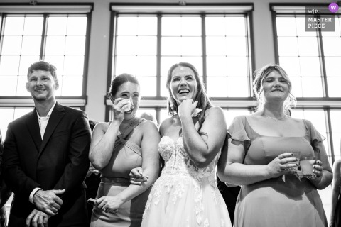 Delight And Emotion Erupt At Sugarbush Resort In Warren, Vermont When Groom Dances With His Mother During Reception. At Sugarbush Resort in Warren, Vermont, the bride and guests react with emotion and delight as the groom dances with his mother during the wedding reception.