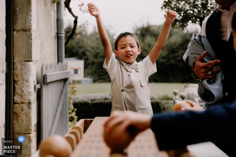   In Paris, energetic children display their playful kid spirit, bringing laughter and joy to the festivities at the outdoor wedding reception.
