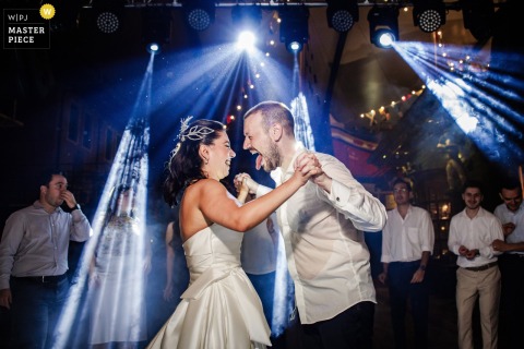   At Koc Museum in Istanbul, the couple enjoy their first dance together at the reception, swaying under the warm summer evening sky surrounded by friends and family.