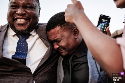   At Urla Sahne in Urla, Izmir, Turkey, the groom’s brother is visibly moved, experiencing deep emotions during the heartfelt wedding ceremony in this scenic Turkish venue.