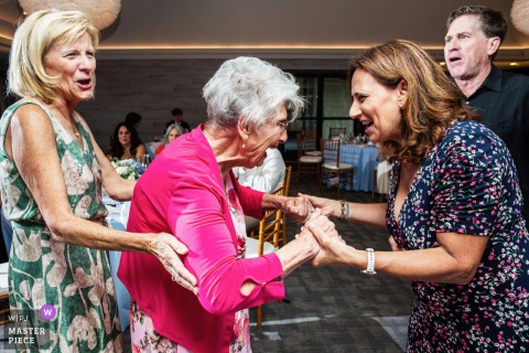 In California, at the reception venue, a candid wedding reception moment with is captured as guests enjoy laughter, connection, and celebration.