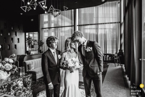At Catalyst, The Farnam Hotel, Omaha, NE, The Bride Shares An Emotional Pre-Ceremony Moment With Her Sons. At Catalyst, The Farnam Hotel in Omaha, NE, the bride and her sons share an emotional moment together before they walk her down the aisle for the heartfelt wedding ceremony.