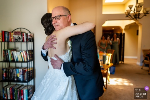 At The Heights Golf Club in San Diego, California, a father embraces his daughter after seeing her wedding dress for the first time, and the room contracts around that tenderness.